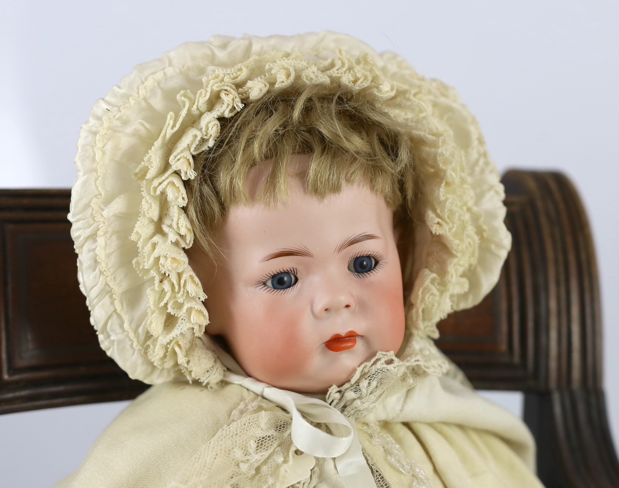 A Kammer & Reinhardt / Simon & Halbig bisque character doll, German, circa 1911, 16in. Please note the chair is for display purposes only.